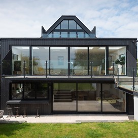 Spacious Holiday Home captures a beautiful view of the sea through Origin Sliding Doors